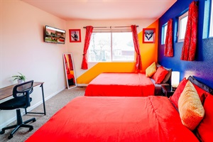 Dream in color! Our cozy haven features two queen-size retreats, a splash of bold red beds, and a workspace bathed in the calming hues of blue with a touch of sunshine yellow. 🛌💙🌞 #ColorfulDreamscape #CozyWorkspace