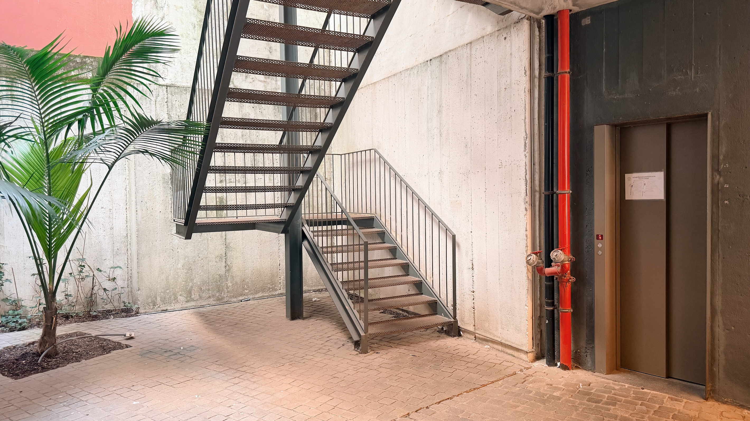 Entry atrium with stairs and elevator.