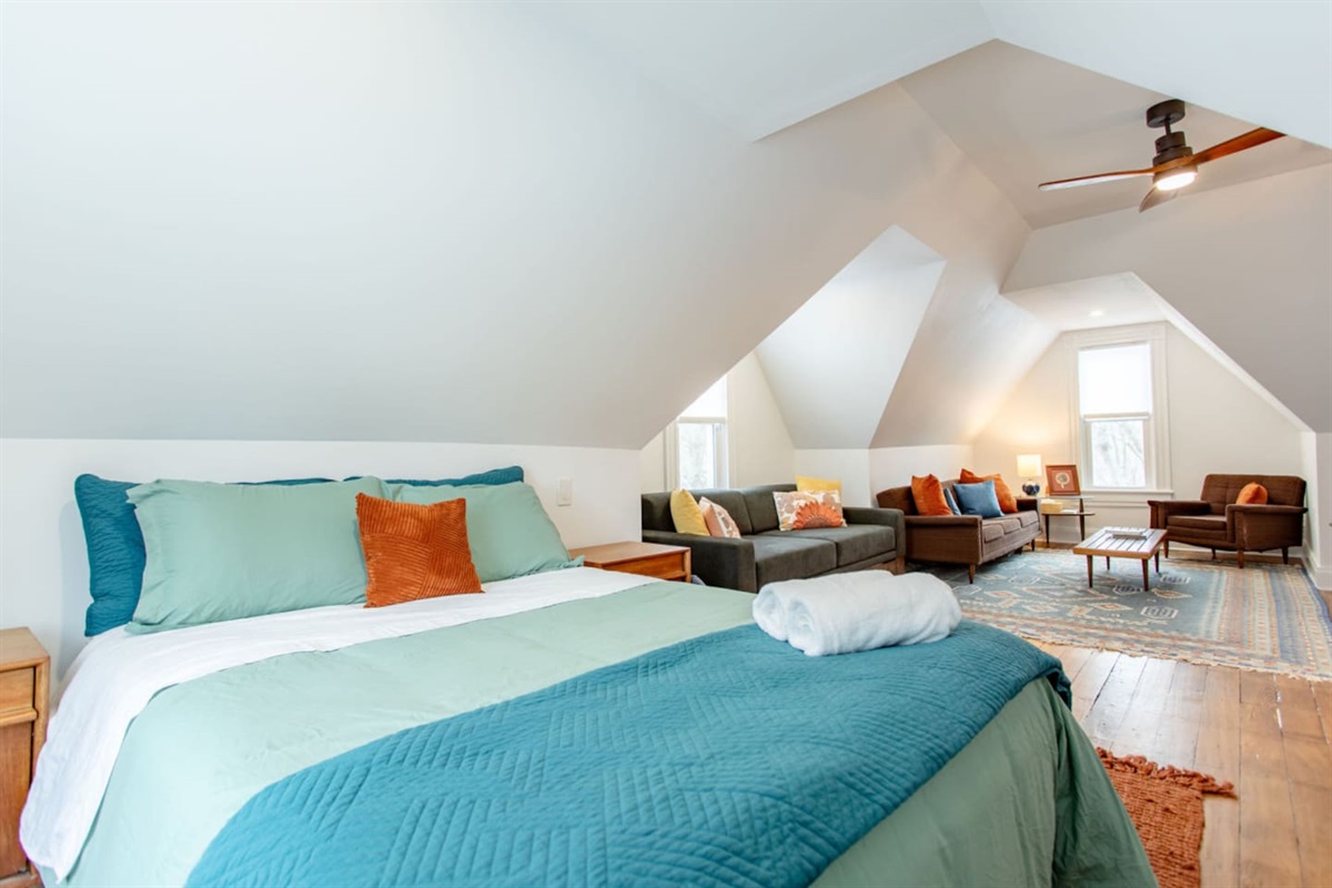 A combined bedroom and living area, where the sleeping space flows seamlessly into a cozy lounge area, offering both comfort and functionality in a unified, spacious environment.