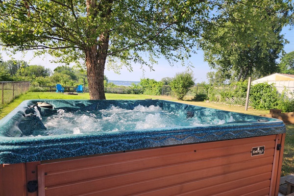 Relax in the private hot tub with a view of Lake Muskegon