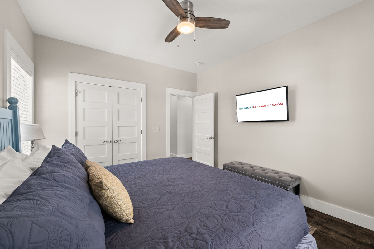 Comfortable king bedroom with fresh bedding, coastal decor & relaxing vacation vibes