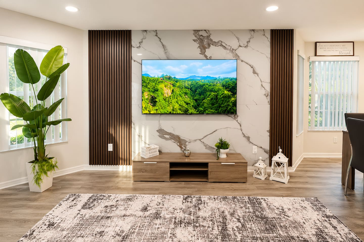 Bright lounge featuring a large TV and a clean, modern design.
