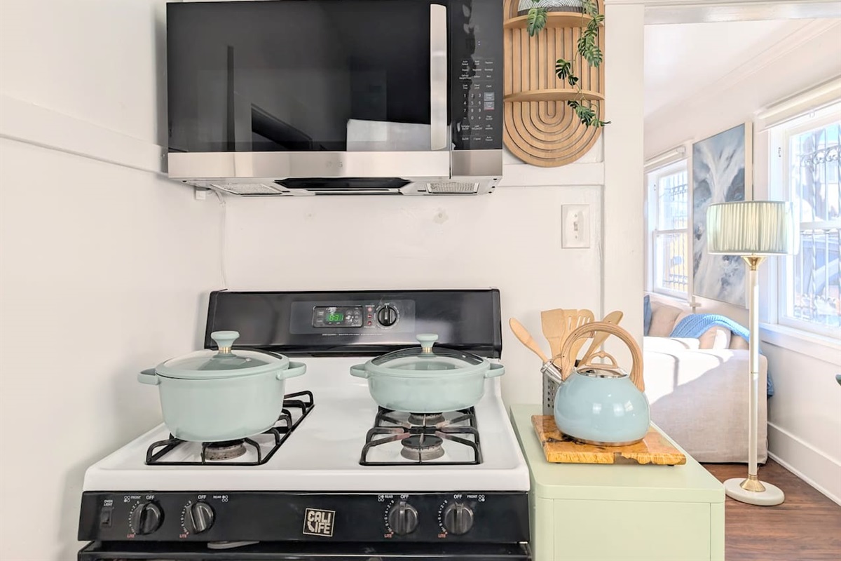 Full kitchen with gas stove, microwave, and cooking essentials.