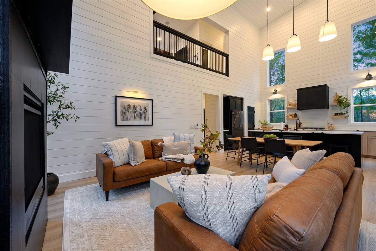 The airy loft above overlooks the main living space, adding to the home’s spacious feel.