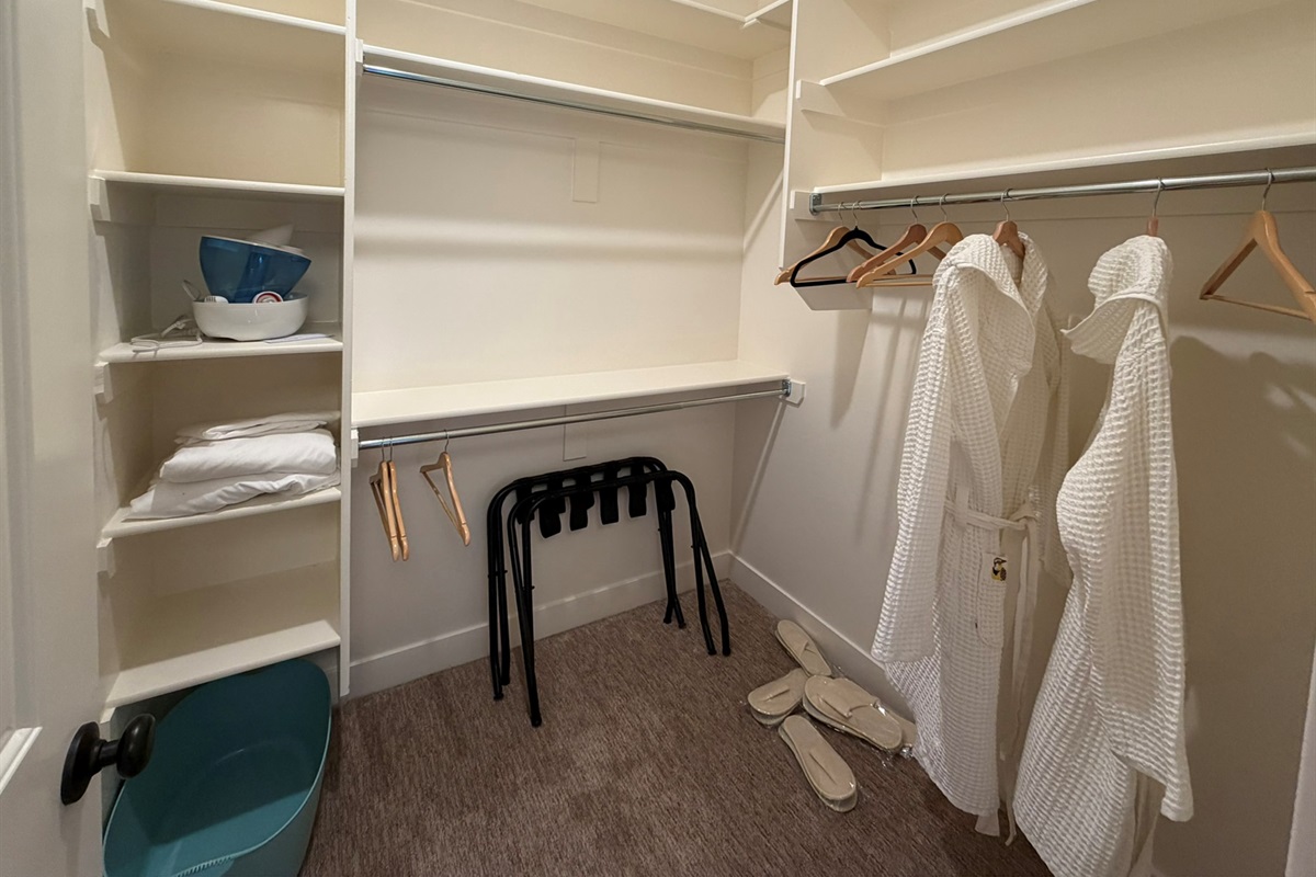 Spacious walk-in closet for the downstairs queen bedroom with plenty of room for luggage and longer stays