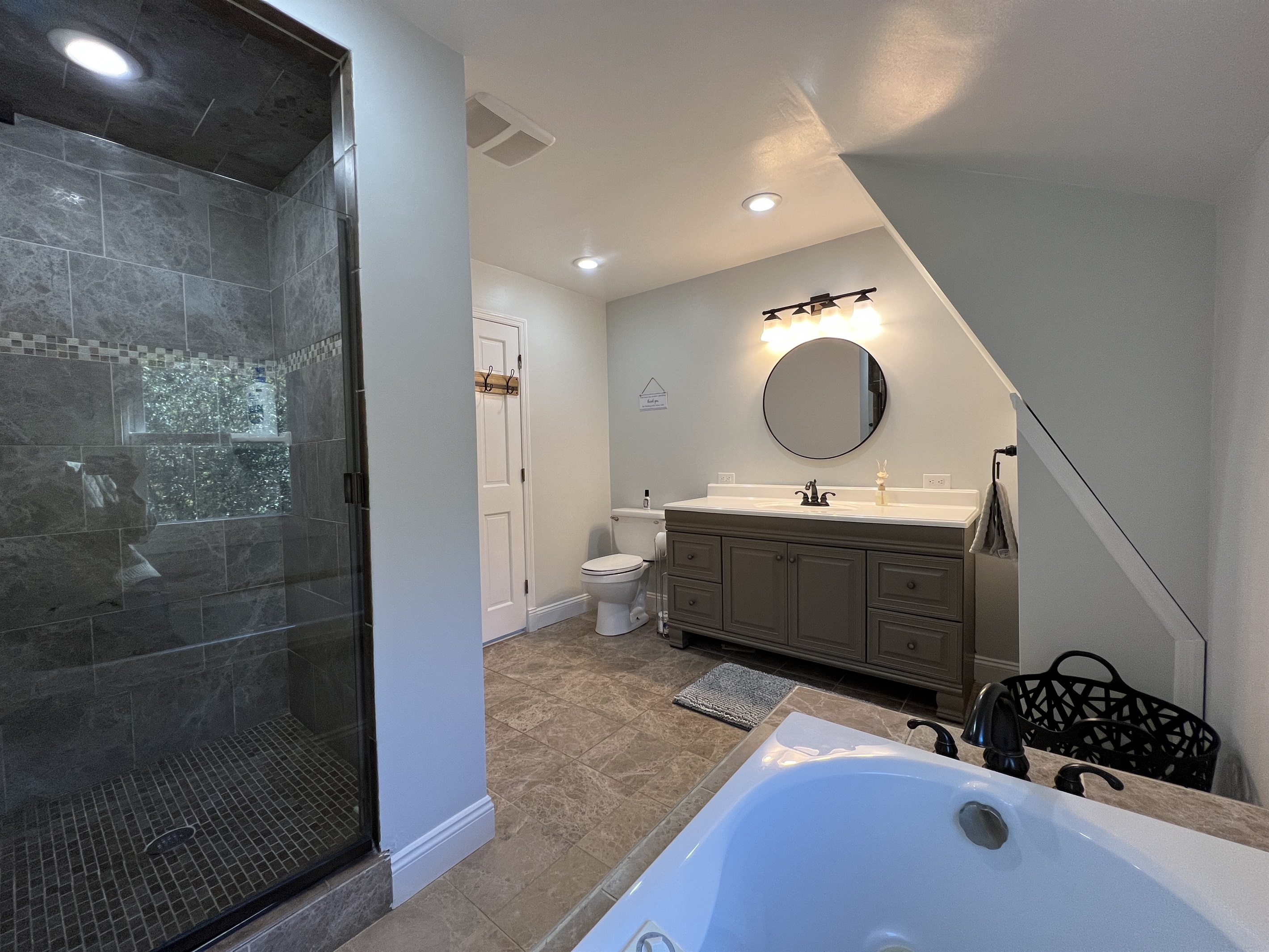 Hilltop Hideaway 2nd Floor full bathroom with glass shower and jetted tub.