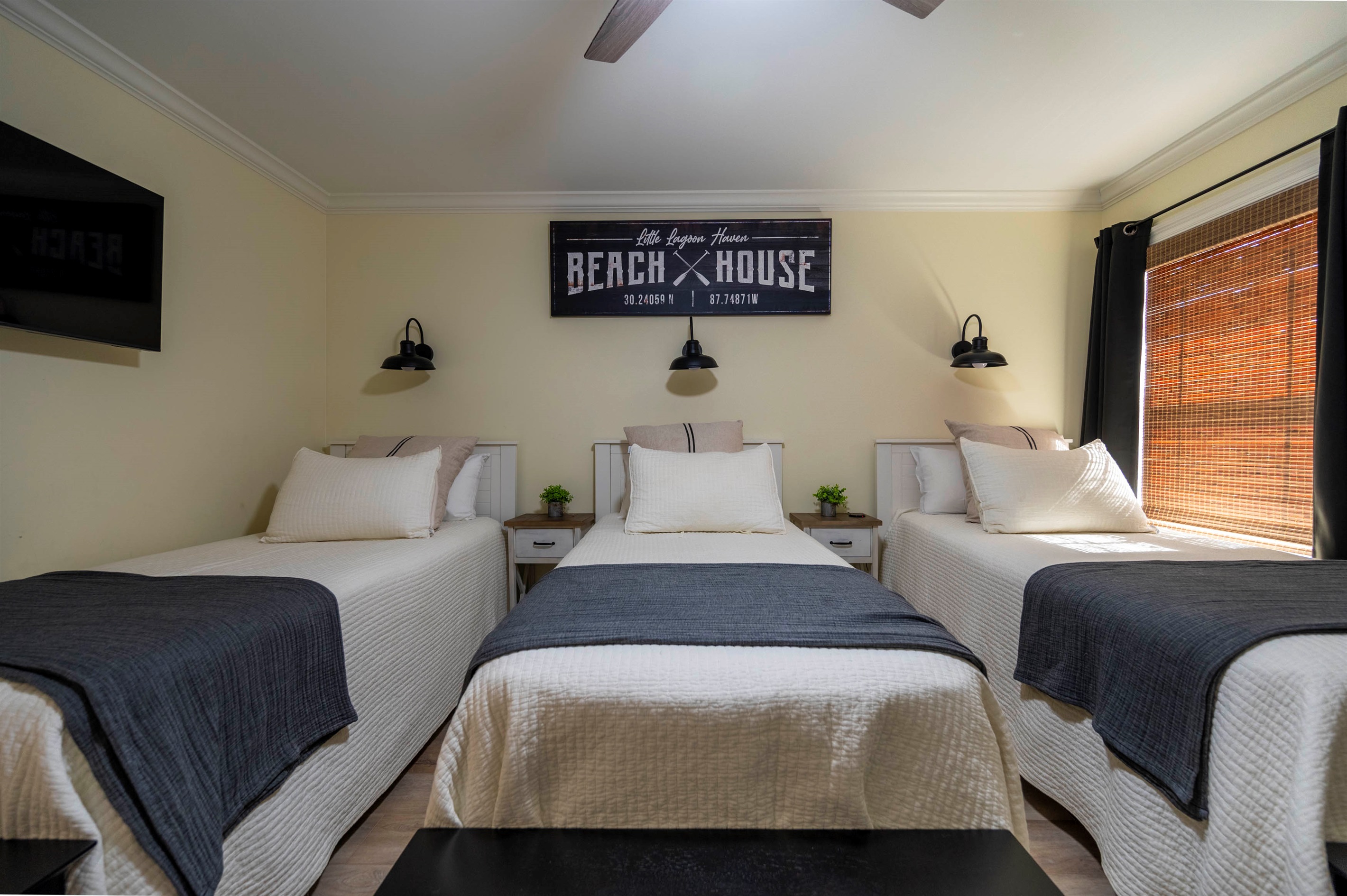 Inviting beach house bedroom with three cozy beds and relaxing coastal charm.