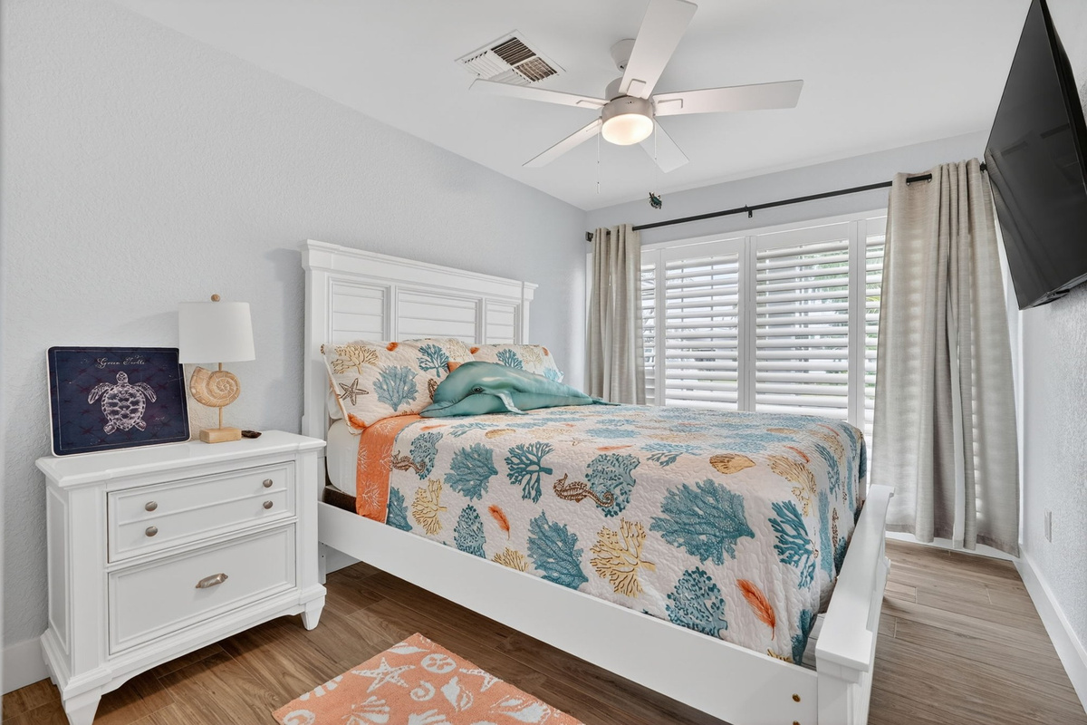 Bedroom with coastal-themed decor and TV