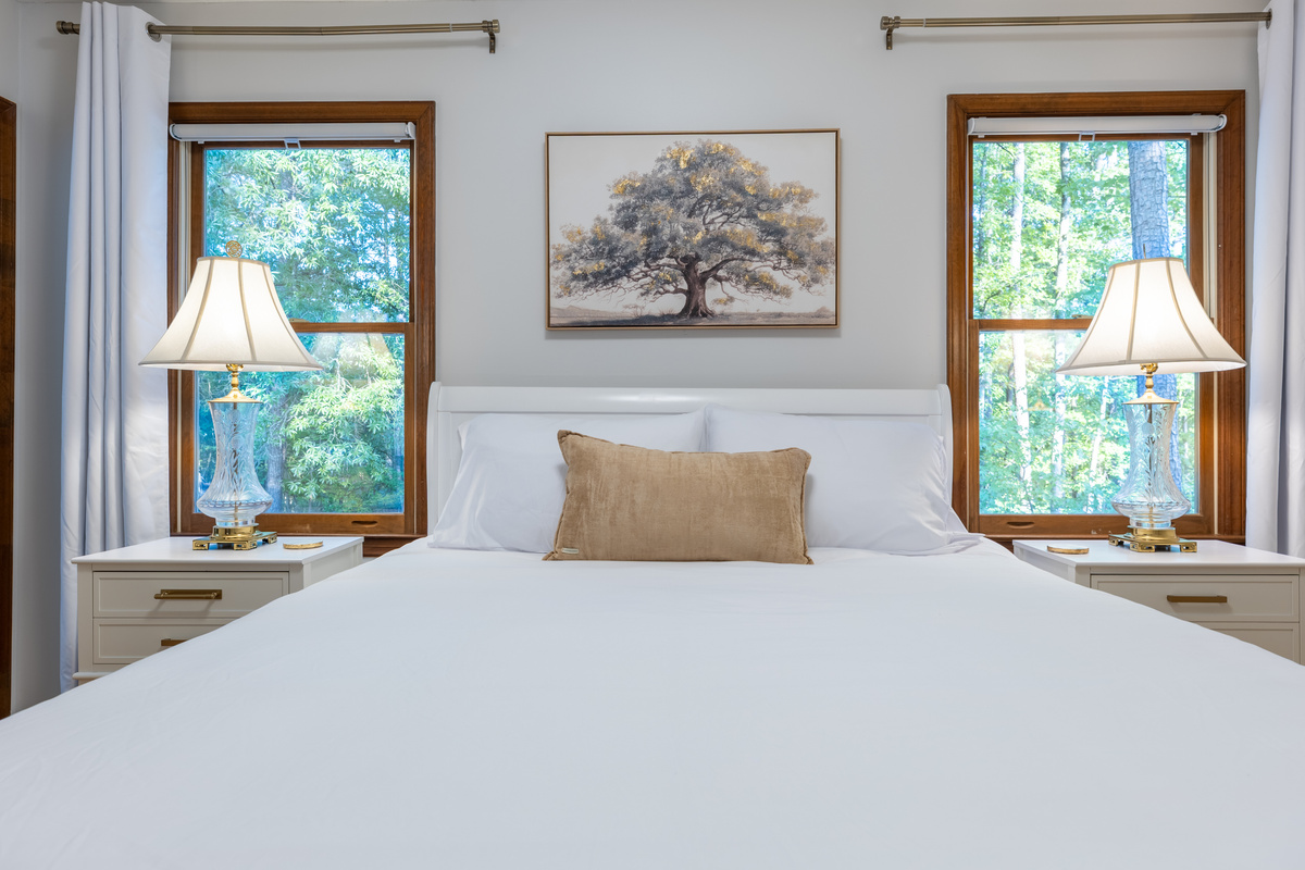 The upstairs master bedroom includes a queen bedroom and a beautifully wooded view.