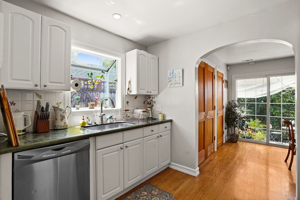 Fully equipped kitchen overlooking the backyard roses.