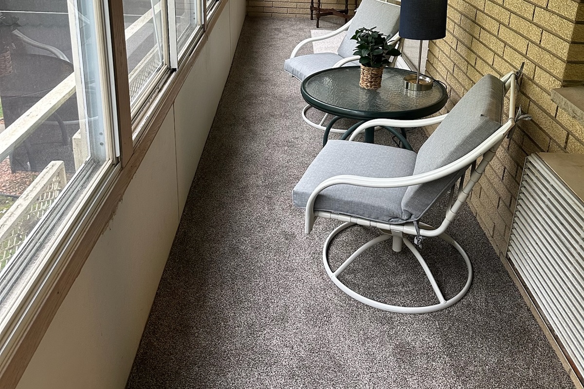 Enclosed balcony off living room and kitchen