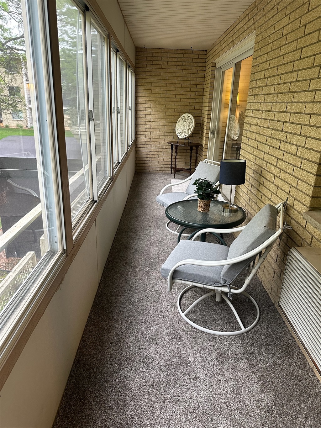 Enclosed balcony off living room and kitchen