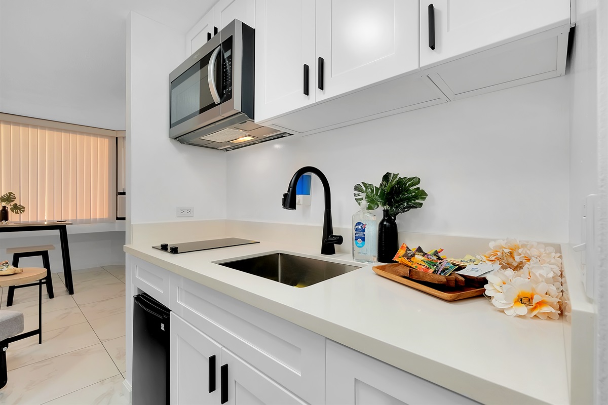 Bright, modern, and inviting — this sleek kitchenette blends island charm with contemporary design. Featuring stainless appliances, smooth quartz counters, and thoughtful tropical touches, it’s the perfect space to enjoy light meals before heading out to e