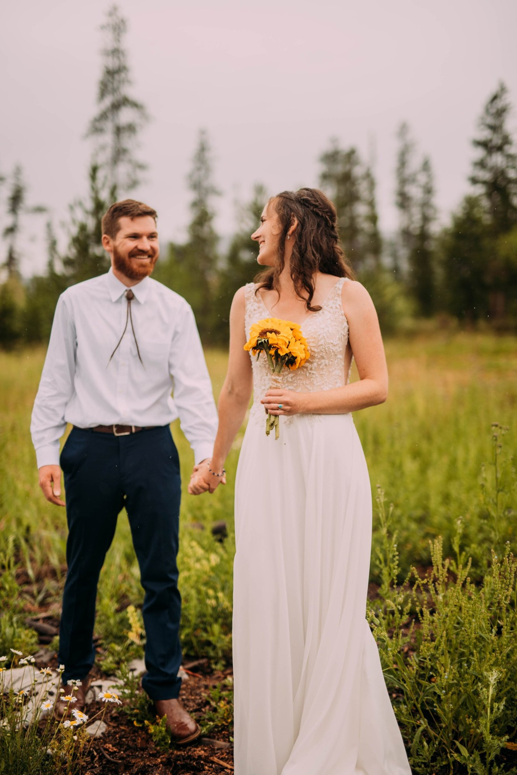 Couple holding hands in the meadow