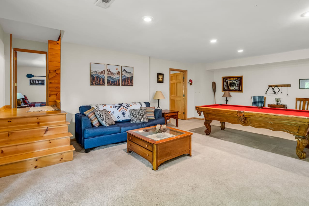 Basement with seating, pool table, dart board, television, and plenty of board games