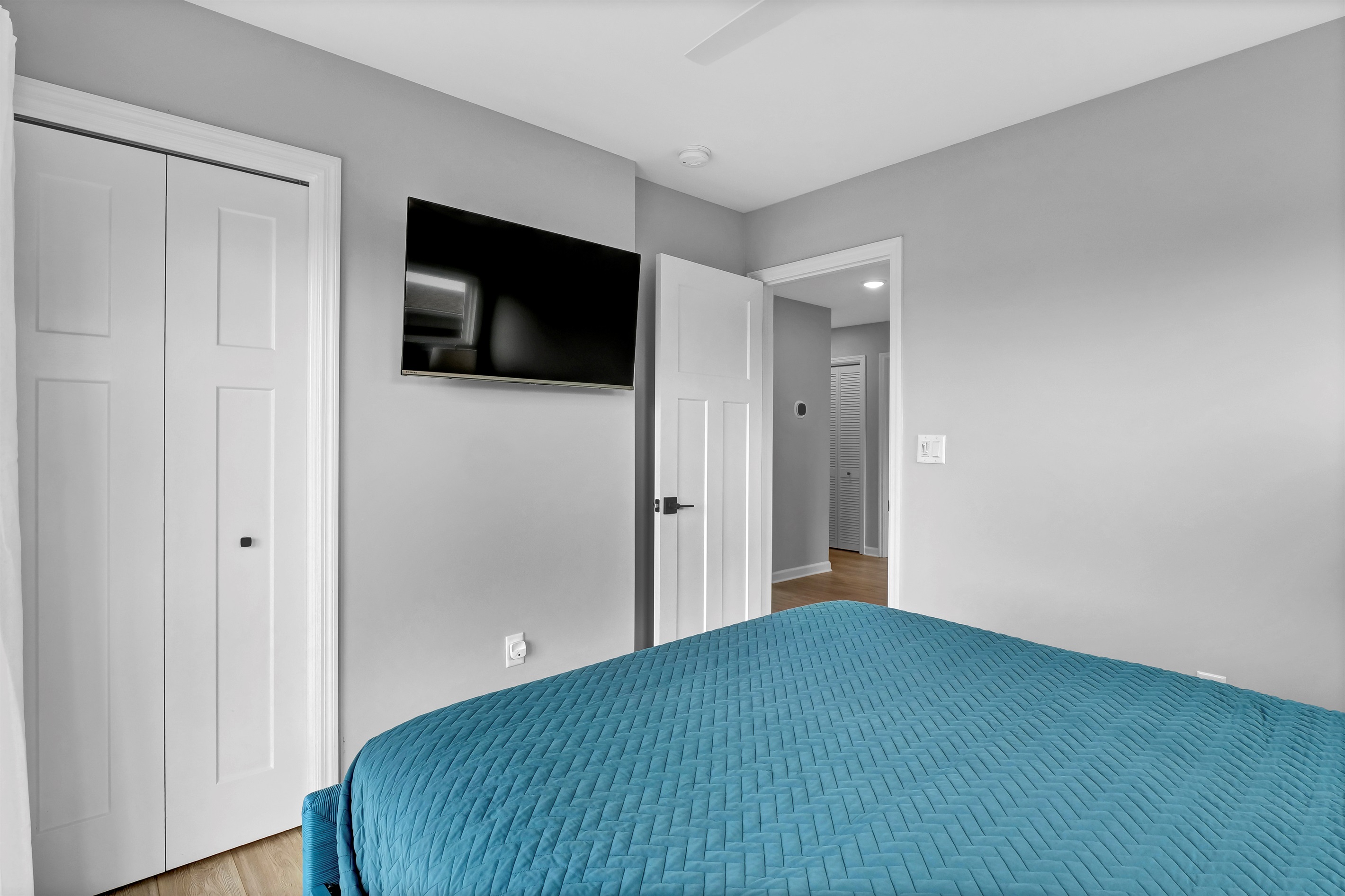 End your beach days with a slight breeze from the ceiling fan and a movie in bed