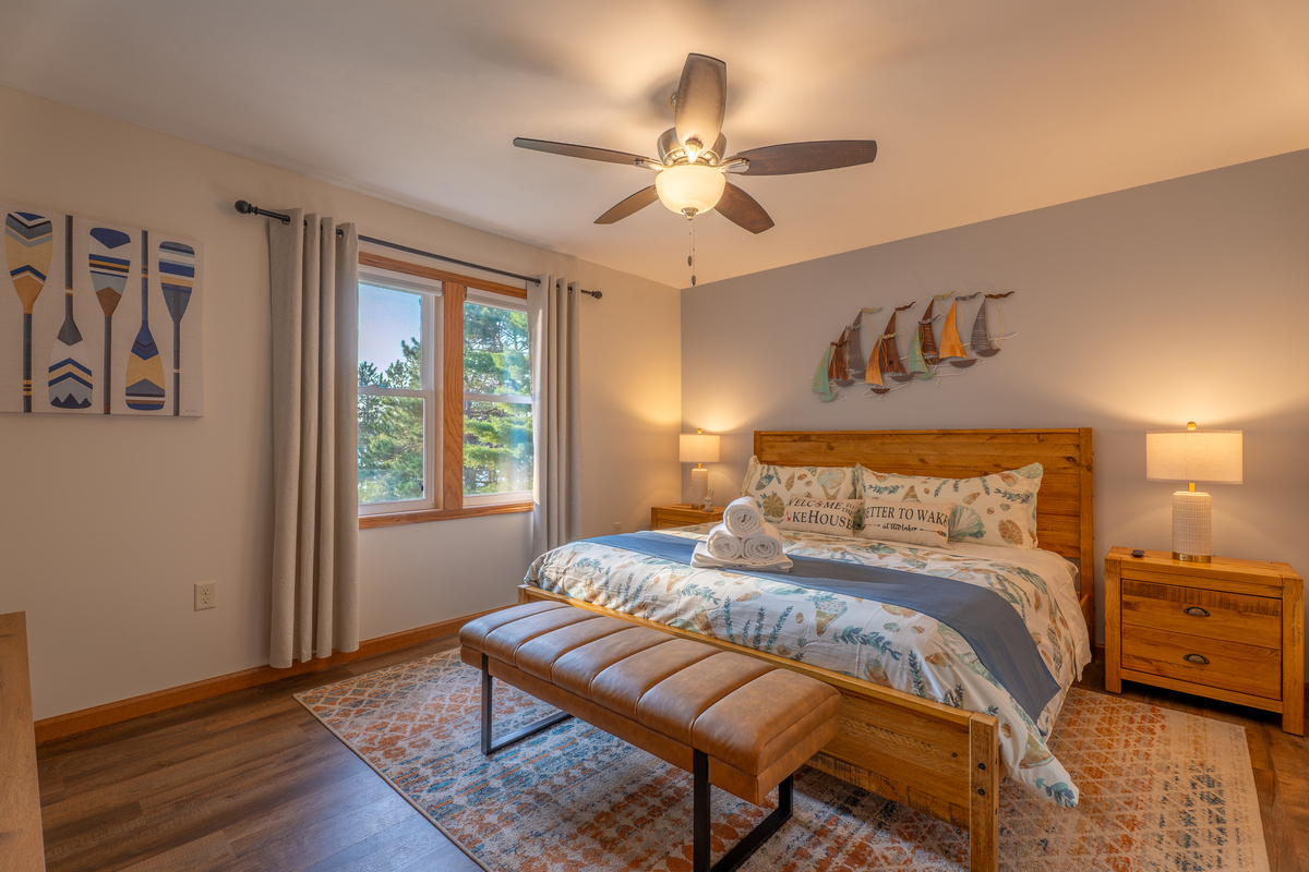 The main floor king master suite - private en-suite bathroom, lake-facing windows, 70" Smart Roku TV, and luxury linens. No bunk beds, ever!