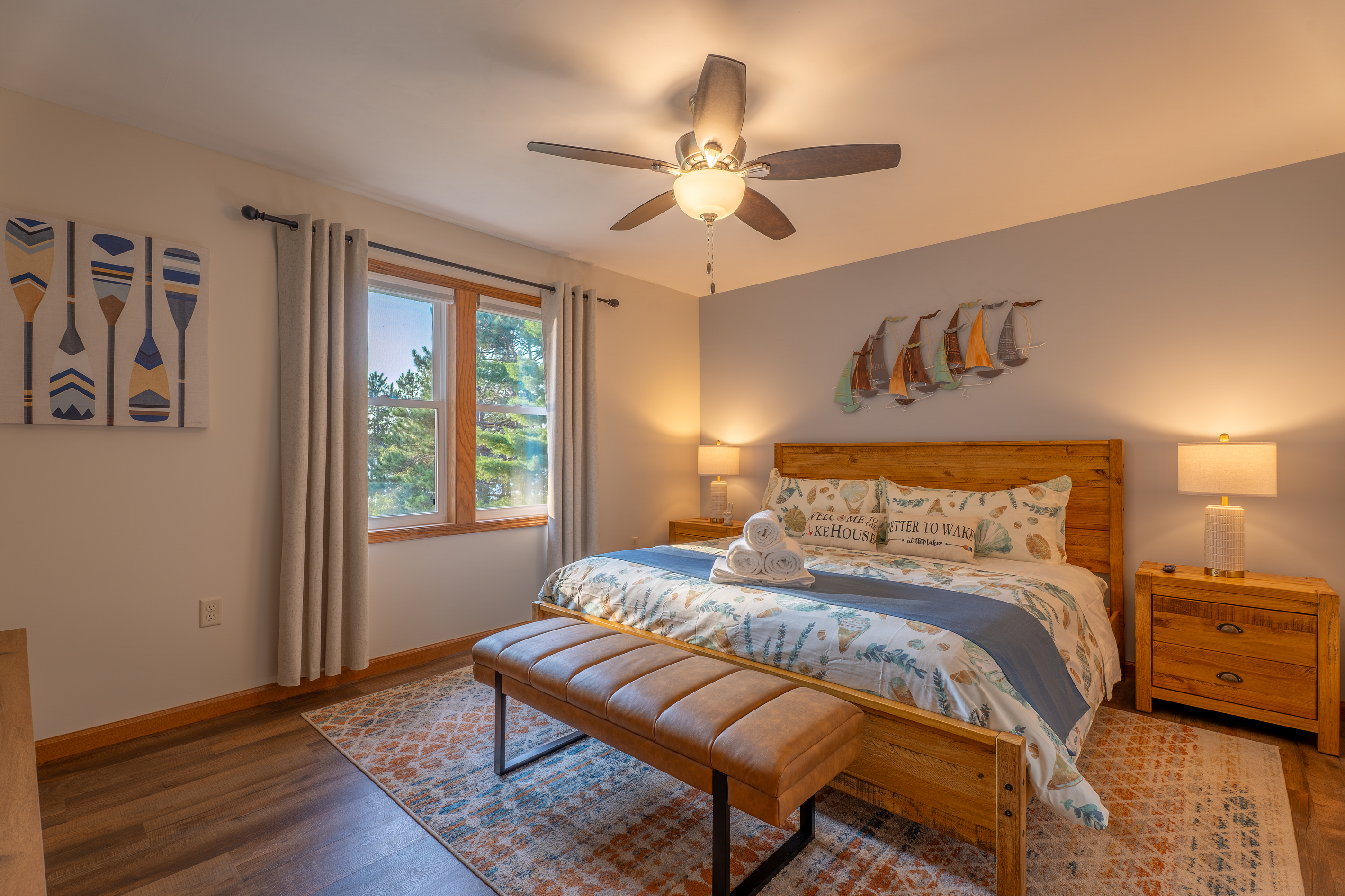 The main floor king master suite - private en-suite bathroom, lake-facing windows, 70" Smart Roku TV, and luxury linens. No bunk beds, ever!