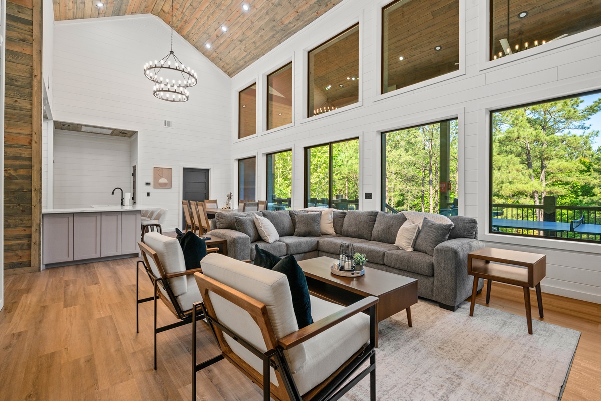 Tall ceilings and large windows help the main gathering space feel airy, spacious, and connected to the outdoors.