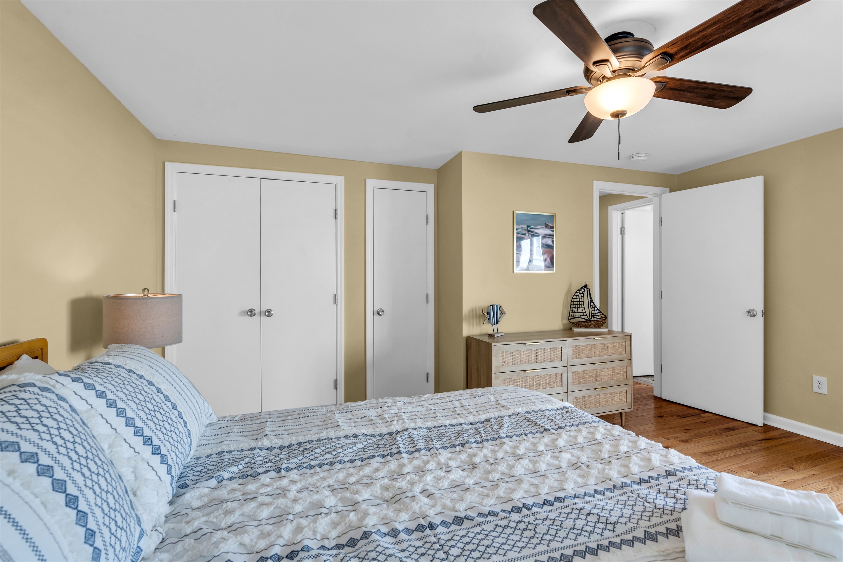 Breezes inside and out with cold A/C window units, ceiling fan and natural light.