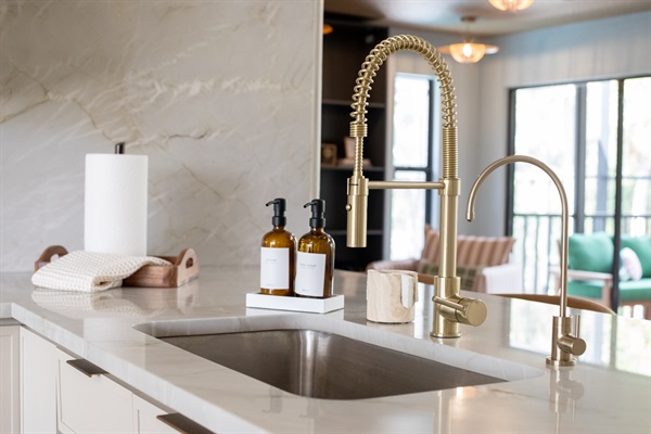 Freshly renovated kitchen with reverse osmosis water bottle filler, modern appliances & a line of sight to Dining and the Locker Room—because hydration, connection, and clean design all matter.