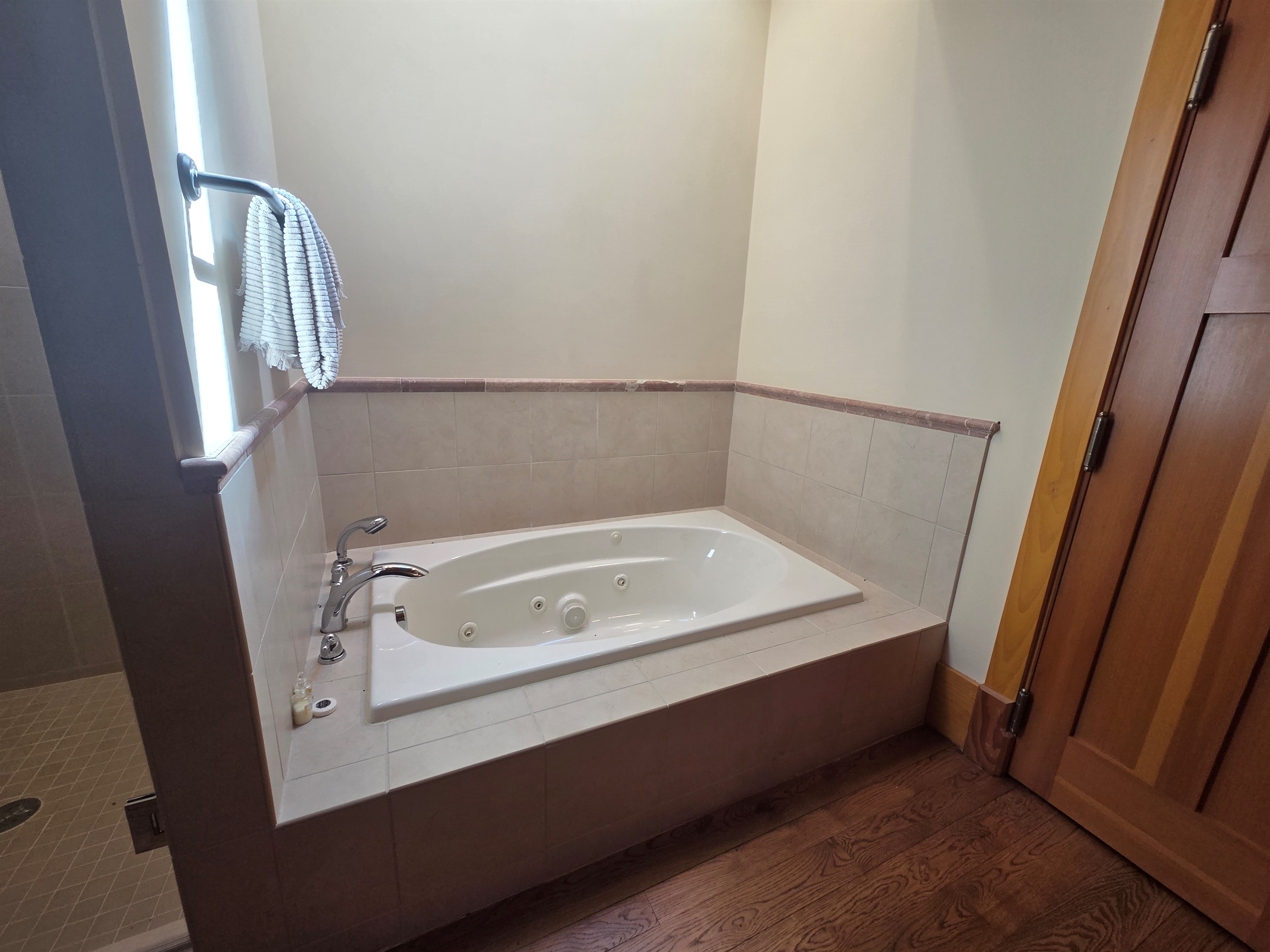 The carriage house includes its own private bathroom, separate from the main house, with a soaking tub and a large walk-in shower for added comfort.