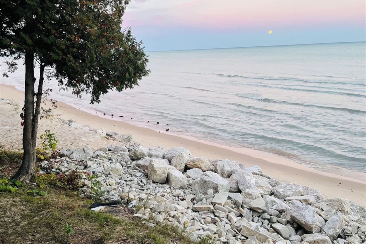 Peaceful shoreline w/ rocky edge & calm water just steps away