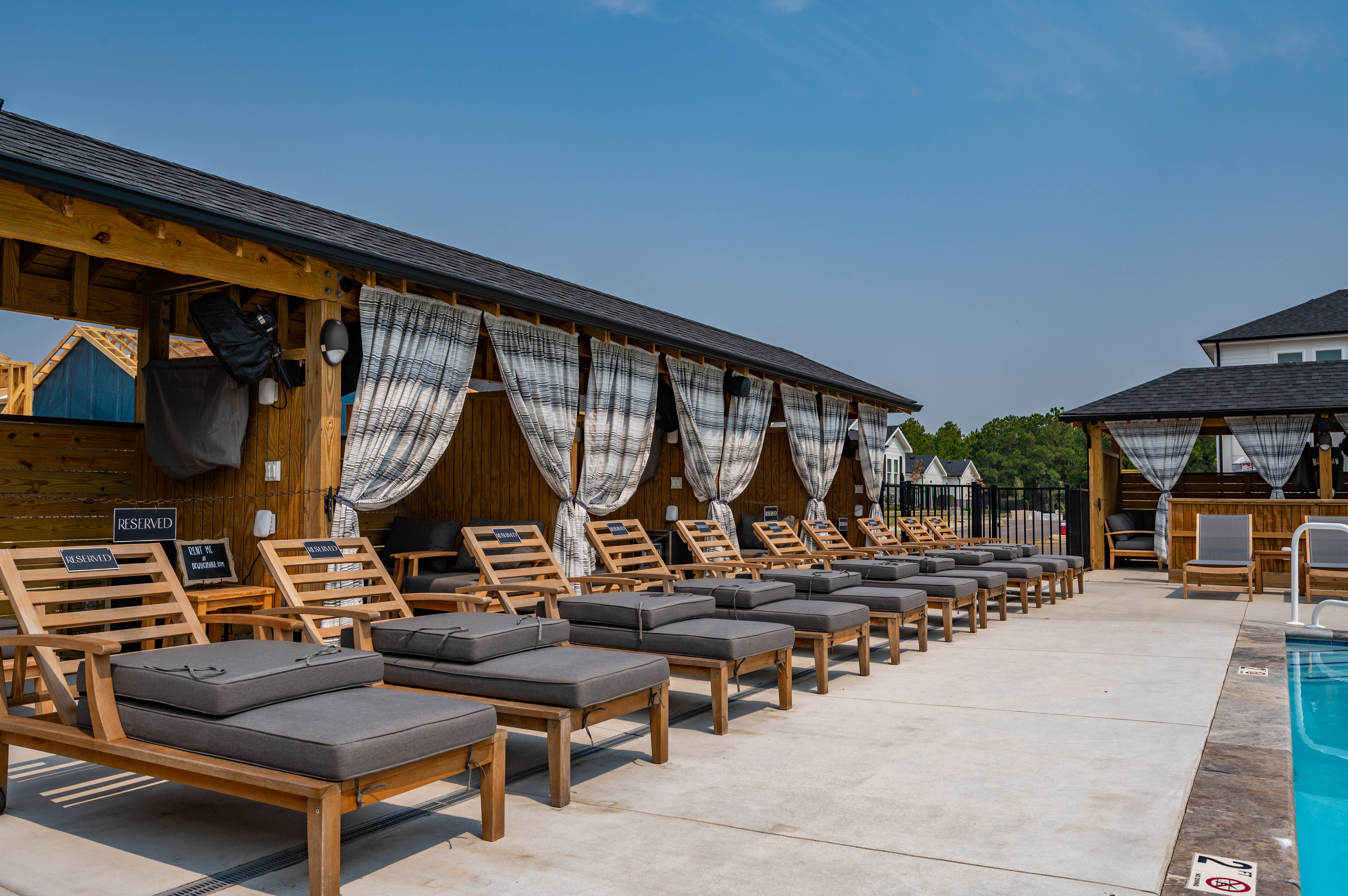 Poolside lounge chairs and cabanas available for rent