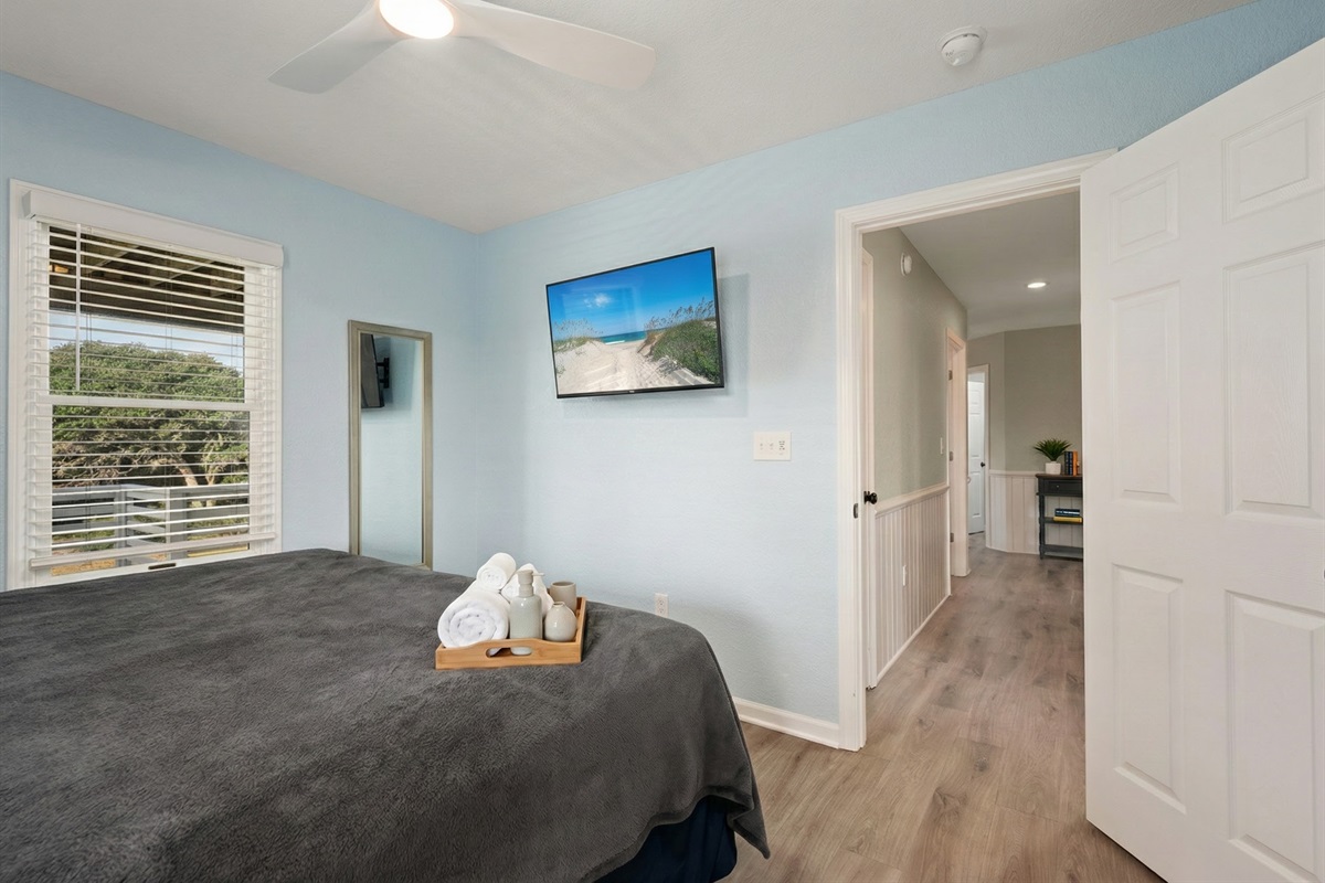 Serene bedroom with calming blue walls and a cozy atmosphere.