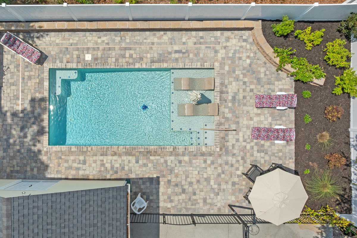 Private pool with lounge chairs, dining set and umbrellas
