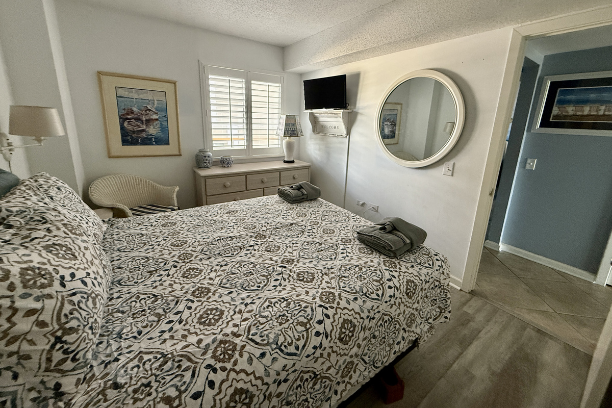 Guest Bedroom with Queen Bed, Plantation Shutters, and Smart TV