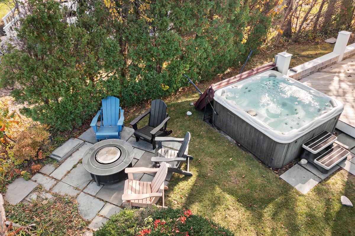 Evenings made perfect with a hot tub, firepit, and Adirondack chairs.