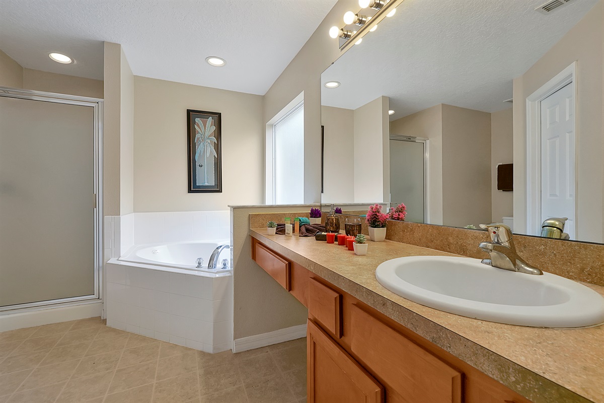 Enjoy the convenience of a walk-in shower and a separate tub in this bright, oversized master ensuite