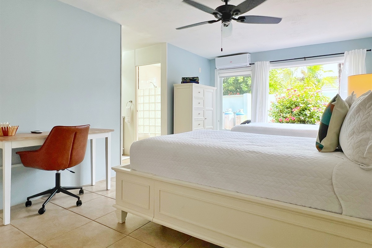 This bedroom features a stylish workspace, perfect for work or creative inspiration. 