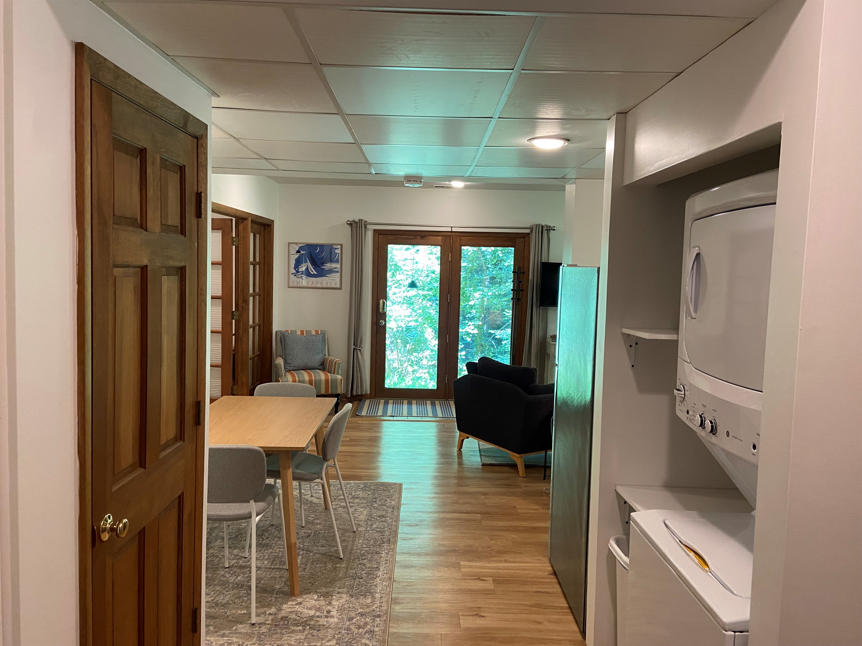 Alternative view of the space; bedroom is to the left. Brown door in view is to a closet with spare supplies and extra hanging space for clothes and coats.