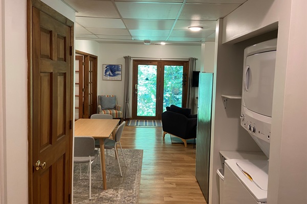 Alternative view of the space; bedroom is to the left. Brown door in view is to a closet with spare supplies and extra hanging space for clothes and coats.