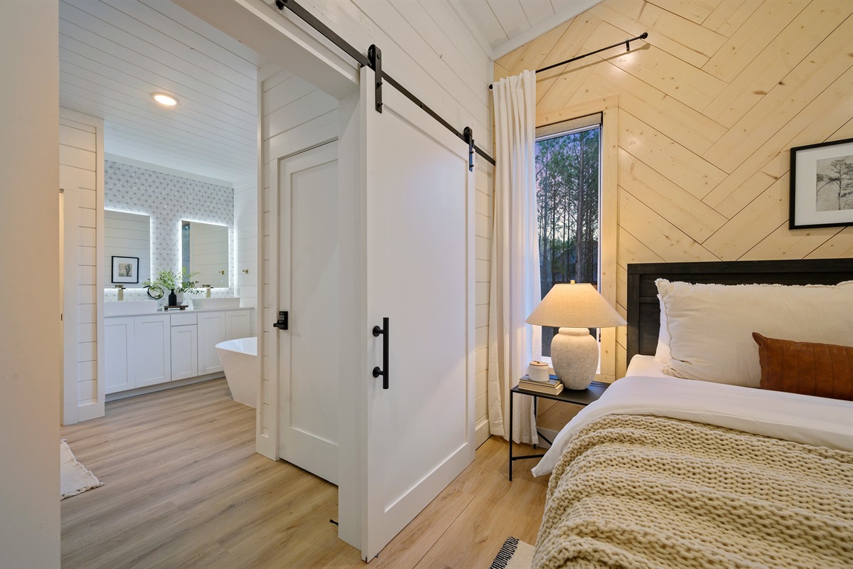 A stylish sliding barn door leads to the spa-inspired ensuite bathroom.