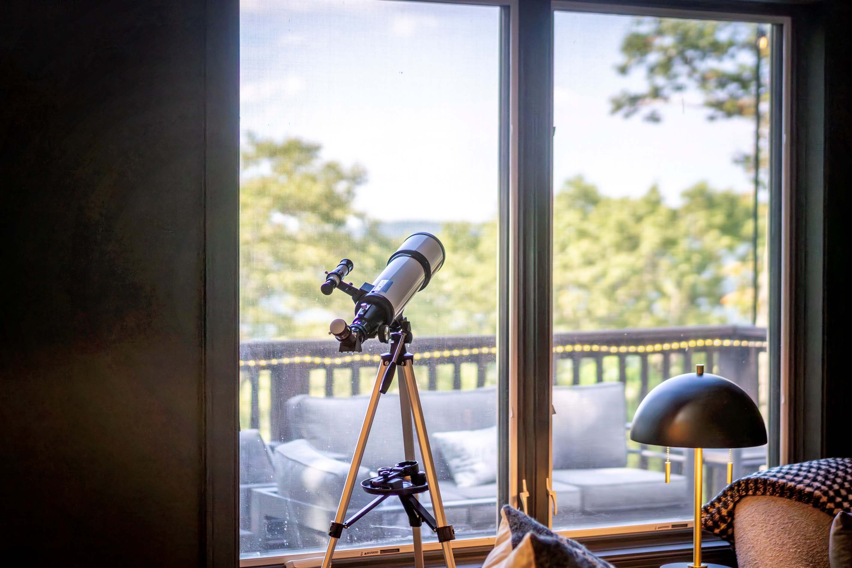 Telescope by the window, blanket at the ready — this corner was made for stargazing, quiet mornings, and scenic stillness