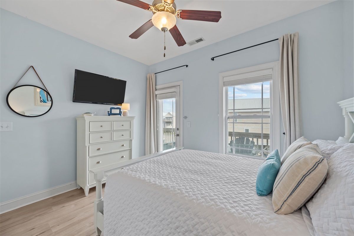 4th bedroom with direct access to the private balcony off the front of the home - relax outside with a drink, stream your favorite show, or unwind in this cozy bed with a good book 