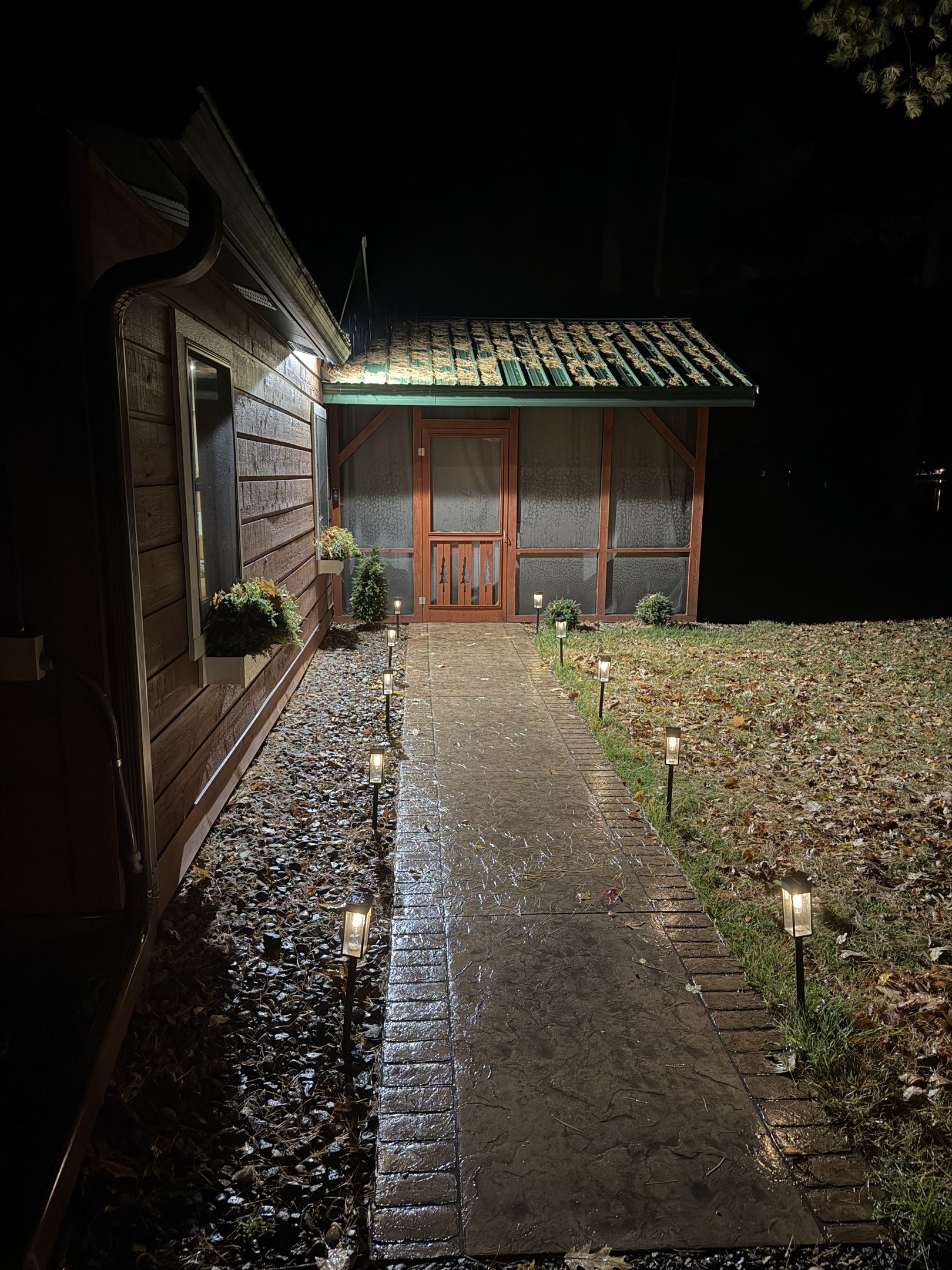 The front walk to the screen porch at night.