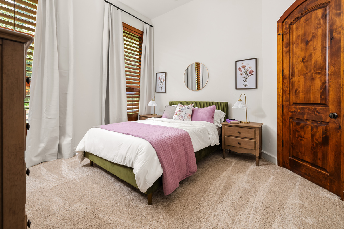 Relax and recharge in refined comfort in this bedroom with its queen-size bed.