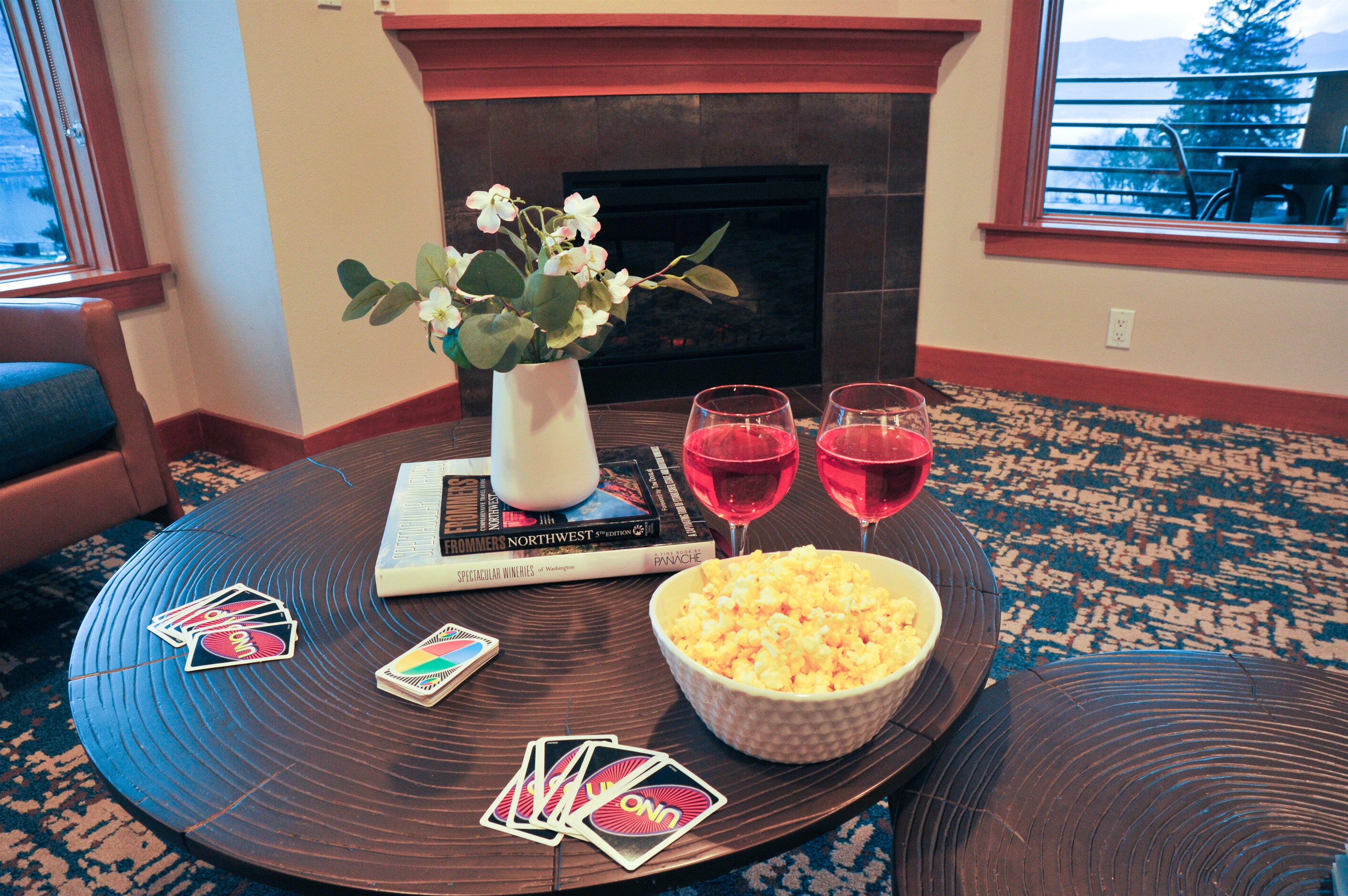 Open living room with TV, fireplace, lake view and with pull out couch