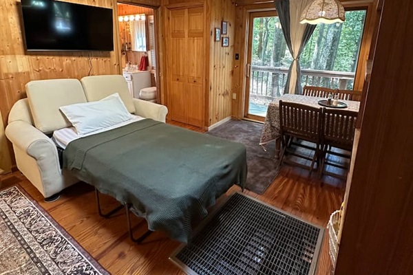Cozy living room with two sleeper sofas — one folds into a twin bed, the other a cot-size. Perfect for extra guests! Fresh bedding is stored in the closet. Ideal for relaxing after a day exploring the orchards, trails, or lakes nearby.