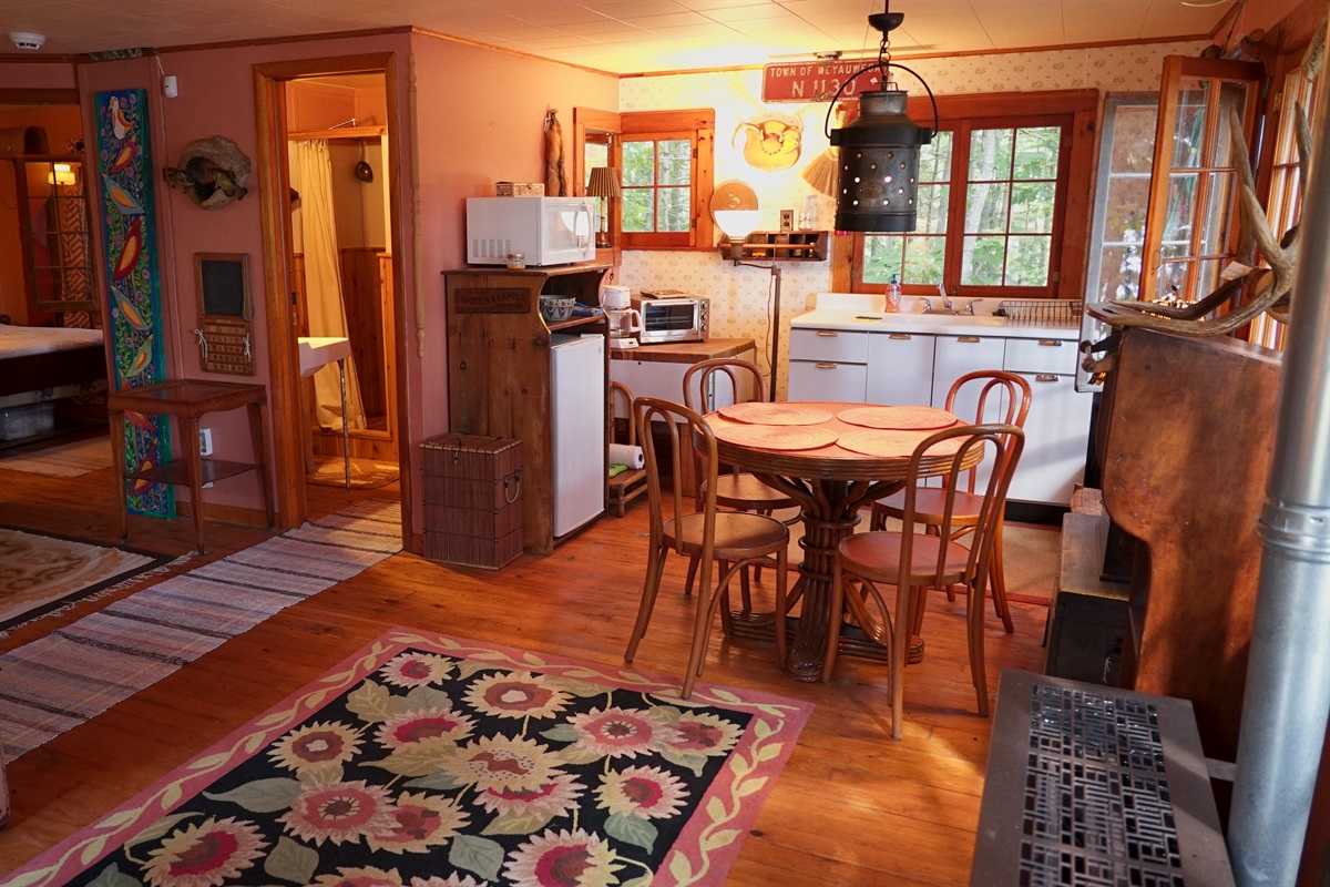 Quaint cottage with kitchenette and dining table.