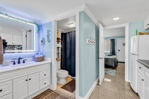 Stylish bathroom with LED-backlit vanity mirror, dual sink, and modern fixtures