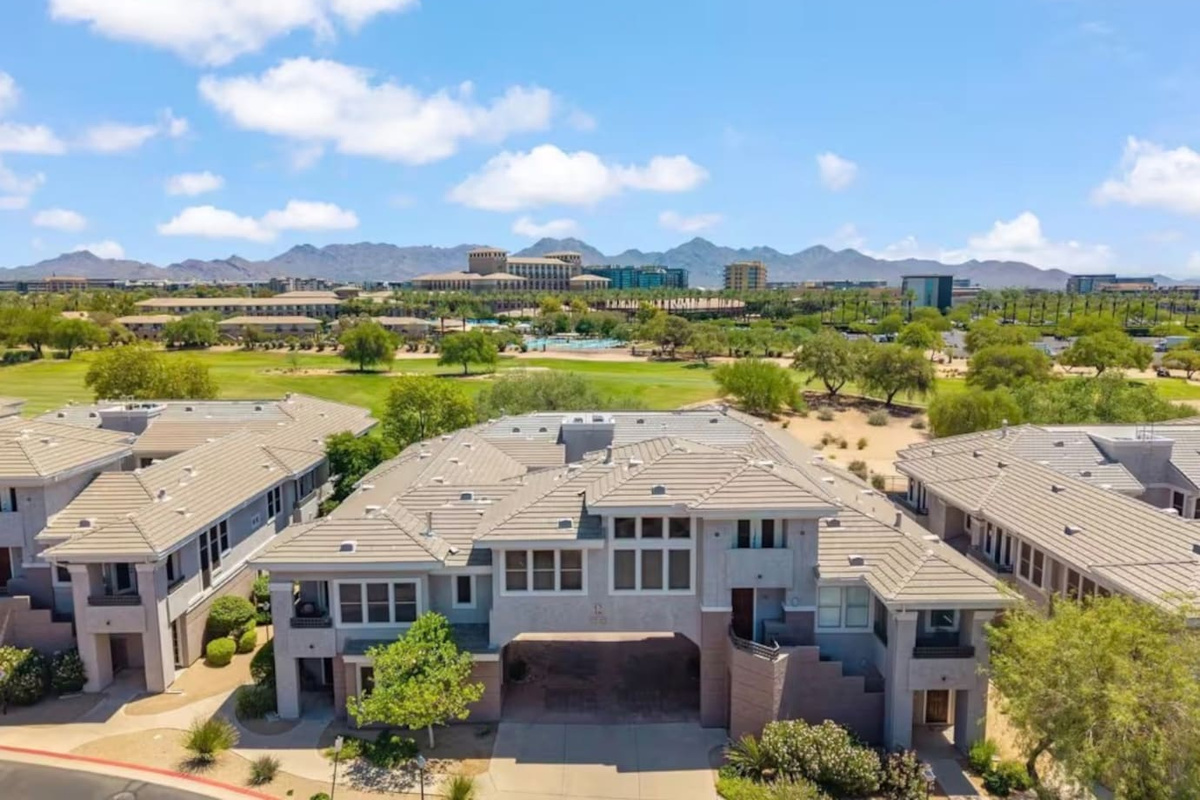 Aerial community view with mountain backdrop, nearby green space, and easy access around the property.