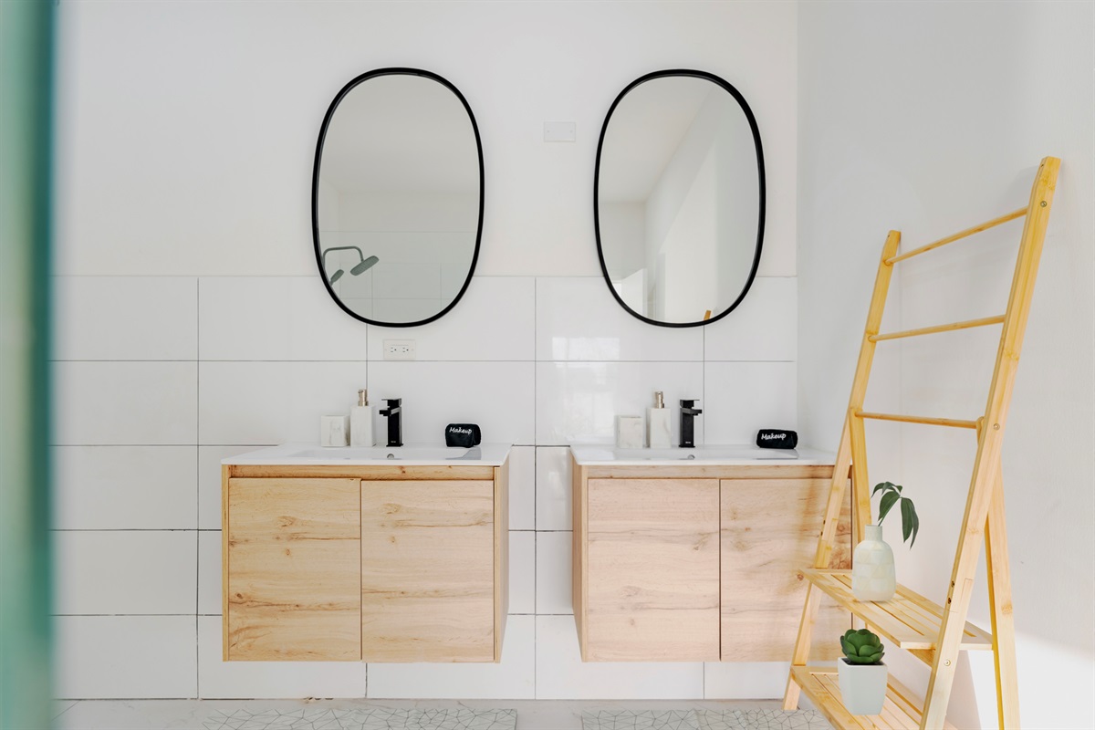 Elegant Bathroom with Dual Circular Mirrors & Wood Vanity