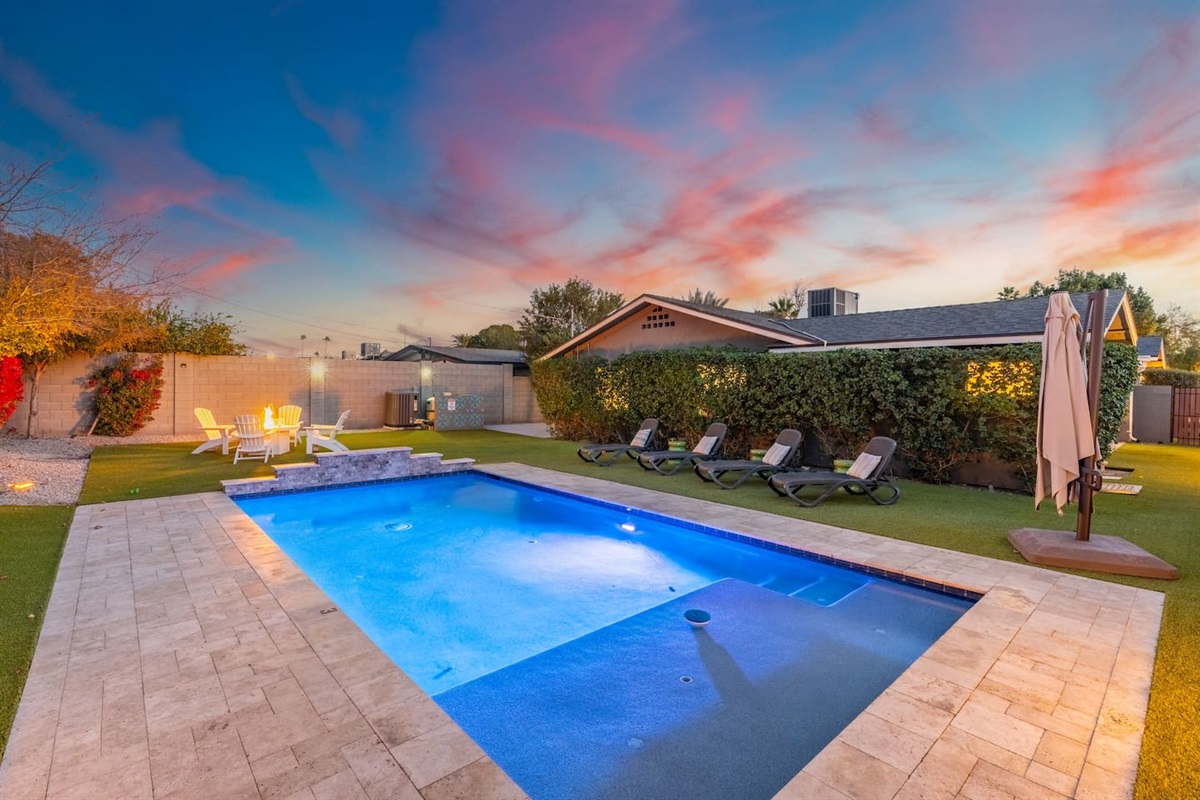 Spacious backyard featuring a refreshing pool, providing a perfect space for relaxation and outdoor activities.