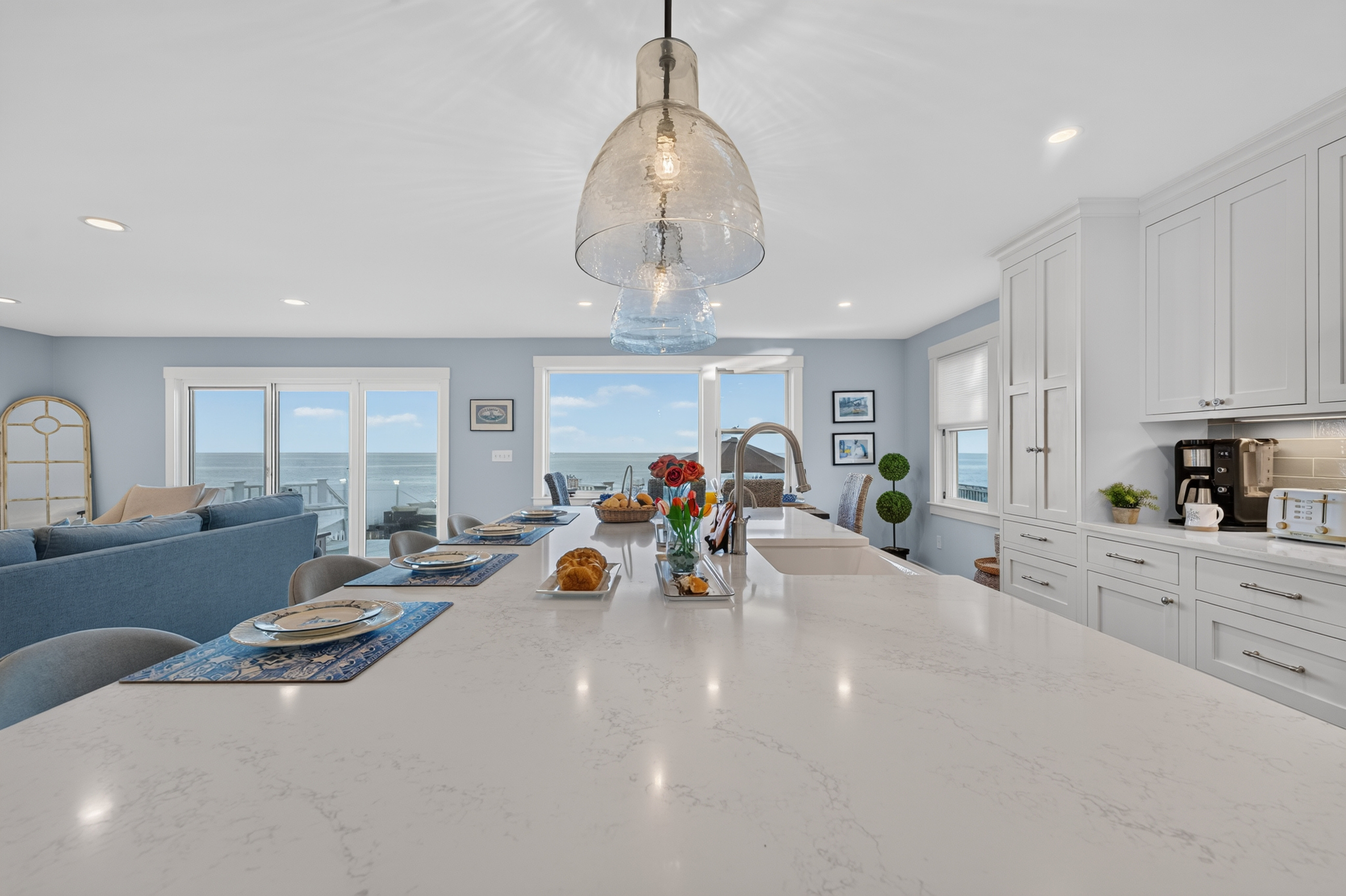 Expansive kitchen island overlooking the living area and beautiful ocean views