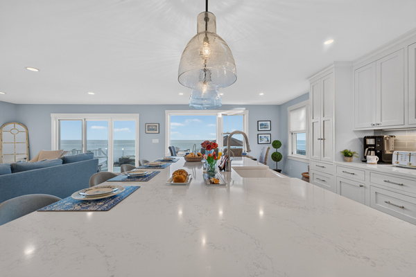 Expansive kitchen island overlooking the living area and beautiful ocean views